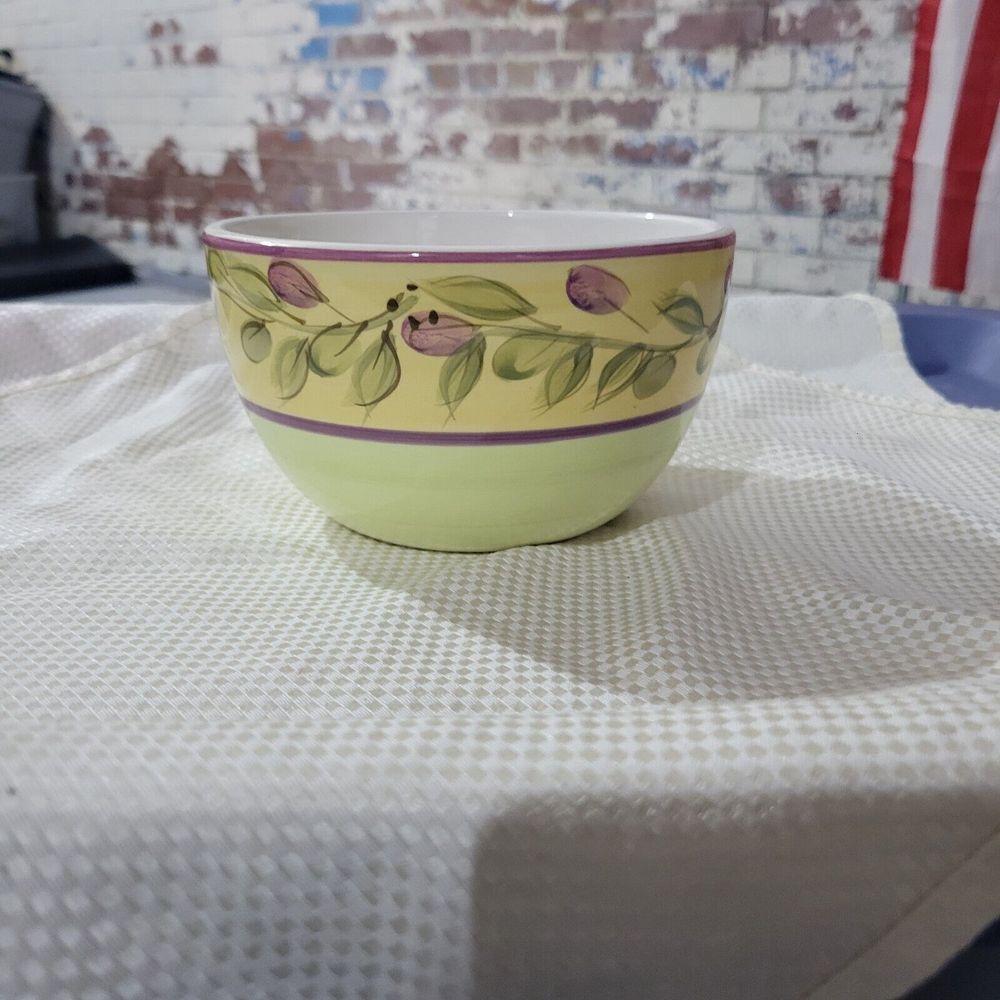 The‎ round  5-3/4" glazed ceramic bowl features a hand-painted pattern of olives